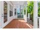 Charming covered porch with wood floors and views of lush landscaping at 916 Hemingway Cir, Tampa, FL 33602