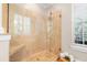 Elegant walk-in shower featuring marble-style tiling, glass door, and a comfortable bench at 916 Hemingway Cir, Tampa, FL 33602