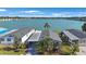 Aerial view of a cozy home nestled on a lake, surrounded by lush landscaping and clear blue waters at 9416 Star Gazer Ln, Riverview, FL 33578