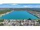 High aerial view showing the expansive lake community surrounded by lush greenery and clear blue skies at 9416 Star Gazer Ln, Riverview, FL 33578