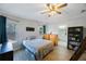 Cozy bedroom offers natural light, wood floors and a view into the ensuite bath at 9416 Star Gazer Ln, Riverview, FL 33578