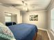 Bedroom featuring wood-look floors, ceiling fan, and a mirrored closet at 9416 Star Gazer Ln, Riverview, FL 33578