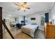 Comfortable bedroom with wood floors, closet with mirrored doors, and a ceiling fan at 9416 Star Gazer Ln, Riverview, FL 33578