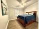 Bedroom features wood-look floors, ceiling fan, and a bed with built-in drawers at 9416 Star Gazer Ln, Riverview, FL 33578
