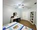 Bedroom featuring wood-look floors, storage shelf, desk and ceiling fan at 9416 Star Gazer Ln, Riverview, FL 33578
