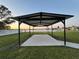 Enjoy outdoor living with this covered carport providing shade and space with a scenic waterfront view at 9416 Star Gazer Ln, Riverview, FL 33578