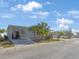 Charming single-story home with a covered carport and well-maintained landscaping featuring mature palm trees at 9416 Star Gazer Ln, Riverview, FL 33578