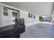 Covered patio area featuring grey siding and black railing with view of the exterior of the home at 9416 Star Gazer Ln, Riverview, FL 33578