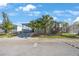 Charming home with well-maintained landscaping featuring palm trees and a covered carport, blending curb appeal at 9416 Star Gazer Ln, Riverview, FL 33578