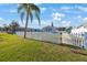 Home's lush green yard, framed by a charming white picket fence, enhances curb appeal at 9416 Star Gazer Ln, Riverview, FL 33578