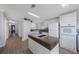 Bright kitchen features white cabinetry, a center island, and stainless steel appliances at 9416 Star Gazer Ln, Riverview, FL 33578
