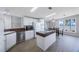 Bright kitchen features modern appliances, a breakfast bar, and a view of the dining area and lake at 9416 Star Gazer Ln, Riverview, FL 33578