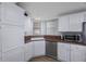 The kitchen features stainless steel appliances, wood floors and ample counter space at 9416 Star Gazer Ln, Riverview, FL 33578