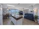 Open-concept living area with lake views, a kitchen island, and a dining table, perfect for entertaining at 9416 Star Gazer Ln, Riverview, FL 33578