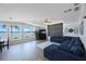Bright living room with views of the water, wood floors, and a comfortable blue sectional sofa at 9416 Star Gazer Ln, Riverview, FL 33578