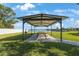 A pavilion with picnic tables provides a nice shaded place by the lake to eat and gather at 9416 Star Gazer Ln, Riverview, FL 33578