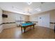 Community recreation room with a billiard table, seating and community information on the walls at 9416 Star Gazer Ln, Riverview, FL 33578