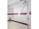 Shower with red and white tile, overhead shower head and corner caddies at 9416 Star Gazer Ln, Riverview, FL 33578