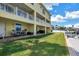 Lovely backyard space with manicured lawn, brick patio, and waterfront access, ideal for outdoor relaxation and entertainment at 100 Windrush Blvd # 1, Indian Rocks Beach, FL 33785