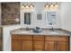 Bathroom featuring double vanities, granite countertop, and modern lighting at 100 Windrush Blvd # 1, Indian Rocks Beach, FL 33785