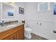 Tastefully decorated half bathroom with granite countertops and updated fixtures at 100 Windrush Blvd # 1, Indian Rocks Beach, FL 33785