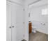 Clean half-bathroom with a toilet and vanity adjacent to a pair of white doors at 100 Windrush Blvd # 1, Indian Rocks Beach, FL 33785