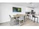Dining area with seating for four near kitchen with granite counters and barstool seating at 100 Windrush Blvd # 1, Indian Rocks Beach, FL 33785