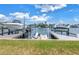 Waterfront property featuring a private dock with boat lift, perfect for boating enthusiasts and waterfront living at 100 Windrush Blvd # 1, Indian Rocks Beach, FL 33785