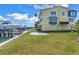 Back of building with lush lawn, boat docks in the background at 100 Windrush Blvd # 1, Indian Rocks Beach, FL 33785