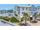 Waterfront townhouse featuring a dock, garage, and lush landscaping, offering serene coastal living with direct water access at 100 Windrush Blvd # 1, Indian Rocks Beach, FL 33785