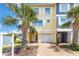Charming two-story townhome with a one-car garage, featuring a well-maintained lawn and landscaping at 100 Windrush Blvd # 1, Indian Rocks Beach, FL 33785