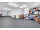 Large garage with ample space, organized storage, and a clean epoxy floor providing a functional and tidy area at 100 Windrush Blvd # 1, Indian Rocks Beach, FL 33785