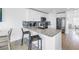 Bright kitchen boasts granite counters, stainless appliances, and seating at the breakfast bar at 100 Windrush Blvd # 1, Indian Rocks Beach, FL 33785