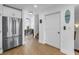 Stainless steel refrigerator in a bright, open kitchen with a doorway leading to other rooms at 100 Windrush Blvd # 1, Indian Rocks Beach, FL 33785