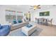 Bright living room featuring modern decor, comfortable seating, and an adjacent dining area at 100 Windrush Blvd # 1, Indian Rocks Beach, FL 33785