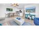 Open living room with kitchen view, wood-look floors, comfortable seating, and modern decor at 100 Windrush Blvd # 1, Indian Rocks Beach, FL 33785