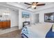 The main bedroom features a ceiling fan and an en suite bathroom with dual sink vanities at 100 Windrush Blvd # 1, Indian Rocks Beach, FL 33785