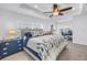 The main bedroom has a ceiling fan and is decorated in blues and whites with a waterfront view at 100 Windrush Blvd # 1, Indian Rocks Beach, FL 33785