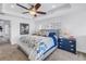 The main bedroom has a ceiling fan, en suite bathroom, and is decorated in blues and whites at 100 Windrush Blvd # 1, Indian Rocks Beach, FL 33785
