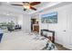 The main bedroom features a ceiling fan, en suite bathroom and waterfront view from its windows at 100 Windrush Blvd # 1, Indian Rocks Beach, FL 33785