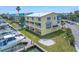 Waterfront townhome with balconies, a dock, and waterfront views, blending outdoor lifestyle with coastal charm at 100 Windrush Blvd # 1, Indian Rocks Beach, FL 33785