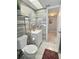 Modern bathroom with gray tiled accent wall, white vanity, and tile flooring at 1001 77Th N Ave # 206, St Petersburg, FL 33702