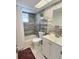 Updated bathroom with tiled walls, shower-tub, modern vanity, and a decorative shelf at 1001 77Th N Ave # 206, St Petersburg, FL 33702
