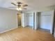 Bright bedroom with hardwood floors, ceiling fan, and closets at 1001 77Th N Ave # 206, St Petersburg, FL 33702