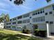 Well-maintained multi-story building with neatly trimmed landscaping and a welcoming entrance at 1001 77Th N Ave # 206, St Petersburg, FL 33702