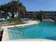 Sparkling blue community pool featuring inviting lounge chairs and clear blue skies at 1001 77Th N Ave # 206, St Petersburg, FL 33702