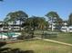 Enjoy the community pool nestled in a serene setting with mature trees and lush landscaping on a sunny day at 1001 77Th N Ave # 206, St Petersburg, FL 33702