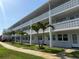 Two story condo complex features balconies with concrete decorative railing and small palm trees at 1001 77Th N Ave # 206, St Petersburg, FL 33702