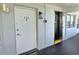 Entrance with unit number 206, nearby elevator, and lantern fixture at 1001 77Th N Ave # 206, St Petersburg, FL 33702