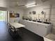 Clean, well-equipped laundry room with multiple washers, table and chairs for convenience at 1001 77Th N Ave # 206, St Petersburg, FL 33702